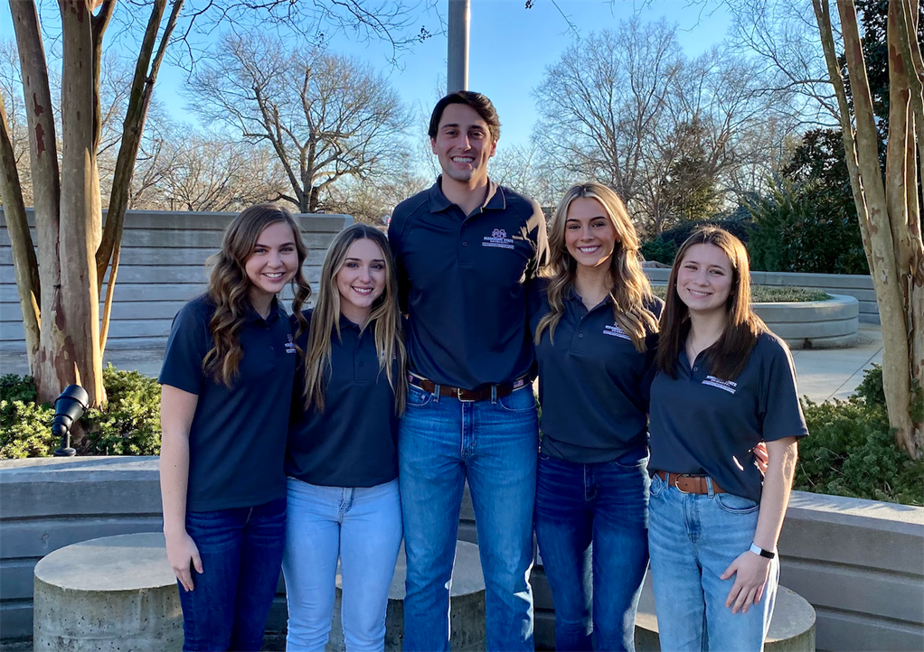 The Ambassadors Executive board in front of the Hunter Henry Center